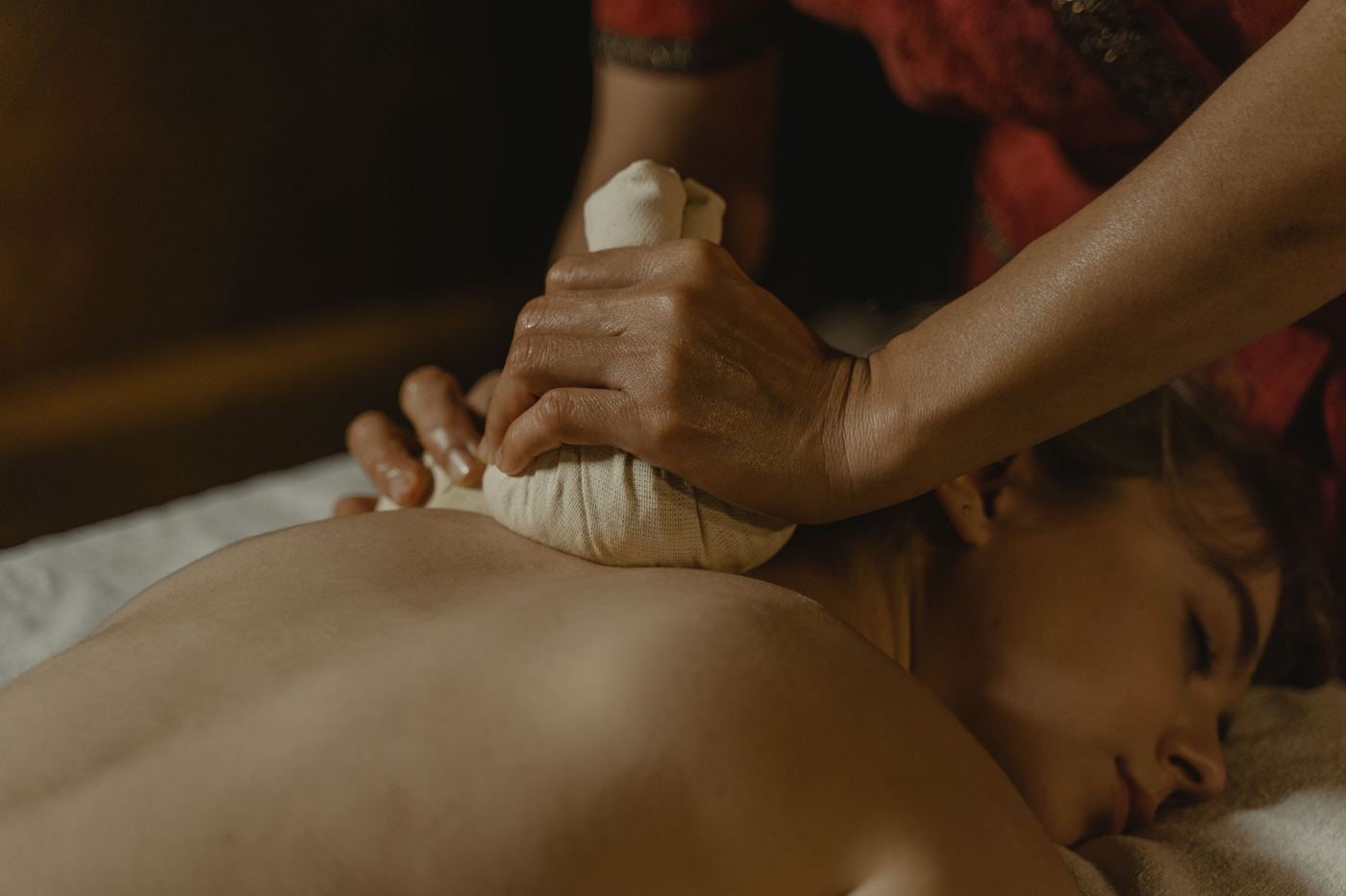 Therapist performing traditional Ayurvedic oil massage